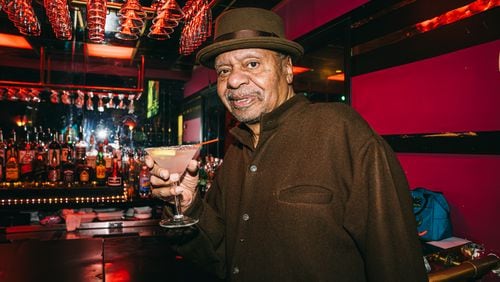Ellery Murphy, age 70, enjoys a drink at his nightclub and lounge, Ellery's,  in southwest Atlanta on Wednesday, Feb. 21, 2024. (Olivia Bowdoin for the AJC).  