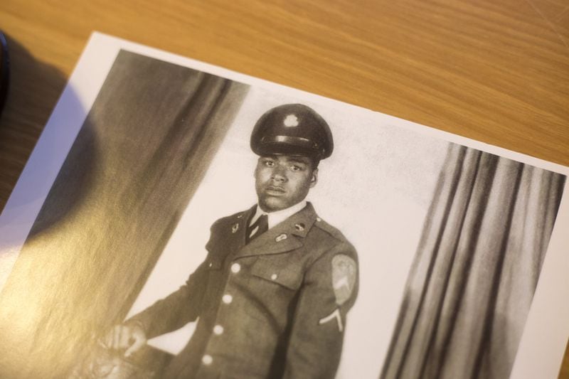 An old photograph shows Harold S. Cole when he enlisted in the Army at age 17. It sits on a desk at his Cobb County home. ALYSSA POINTER/ALYSSA.POINTER@AJC.COM