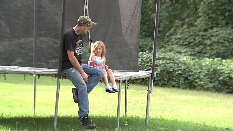 Zoey Levandowski, age 5, pictured with her father, Andy Levandowski, says she was bullied by an older boy at North Douglas Elementary School. JUSTIN CRATE / WSB-TV