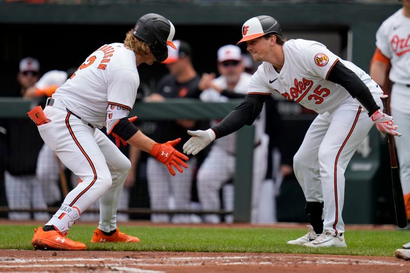 Baltimore Orioles' Gunnar Henderson (2) celebrates his home run with Adley Rutschman (35) during the first inning of a baseball game against the Minnesota Twins, Wednesday, April 17, 2024, in Baltimore. The Orioles won 4-2. (AP Photo/Jess Rapfogel)