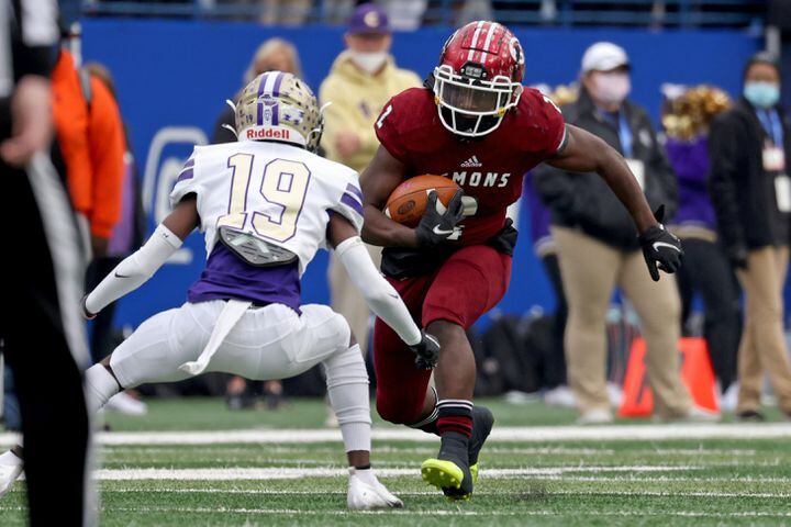 Warner Robins running back Jahlen Rutherford (2) rushes against Cartersville defensive back Jaqualyn Mayhall (19) in the first half of the Class 5A state high school football final at Center Parc Stadium Wednesday, December 30, 2020 in Atlanta. JASON GETZ FOR THE ATLANTA JOURNAL-CONSTITUTION