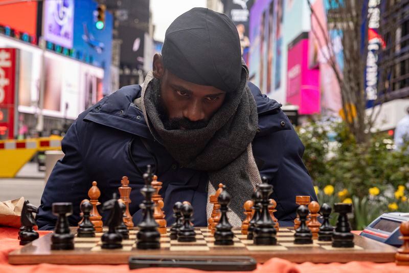 Tunde Onakoya, a Nigerian chess champion and child education advocate, plays a chess game in Times Square, Friday, April 19, 2024, in New York. (AP Photo/Yuki Iwamura)