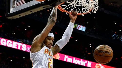 Atlanta Hawks forward Kent Bazemore (24) dunks during the first half of an NBA basketball game, Saturday, Feb. 4, 2017, in Atlanta. (AP Photo/John Amis)