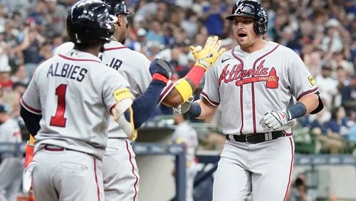 Atlanta Braves' Austin Riley is congratulated by Ronald Acuna Jr. and Ozzie Albies after hitting a three-run home run during the third inning of a baseball game against the Milwaukee Brewers Saturday, July 22, 2023, in Milwaukee. (AP Photo/Morry Gash)