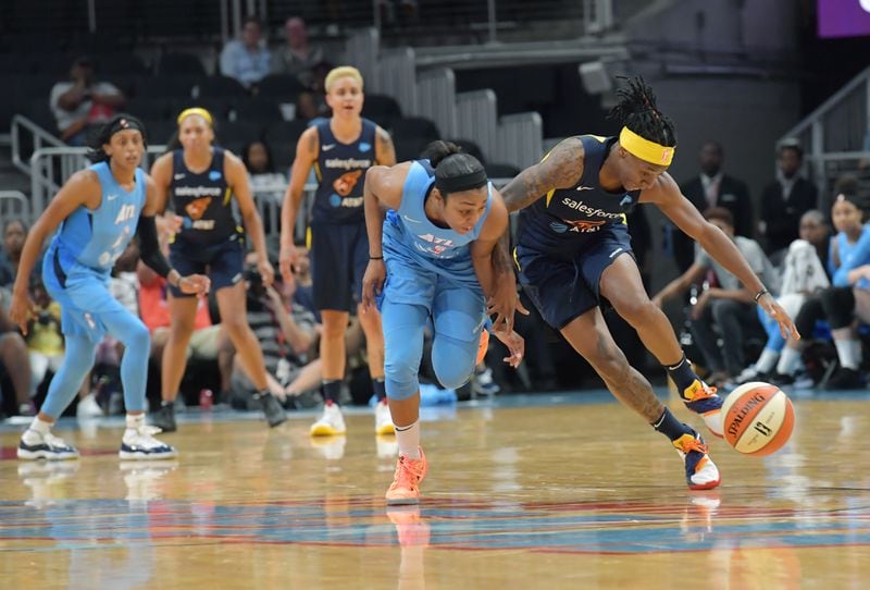 June 19, 2019 Atlanta - Atlanta Dream guard Renee Montgomery and Indiana Fever guard Erica Wheeler (right) fight for a loose ball during the second half of WNBA basketball game at State Farm Arena in Atlanta on Wednesday, June 19, 2019. Atlanta Dream won 88-78 over the Indiana Fever. HYOSUB SHIN / HSHIN@AJC.COM