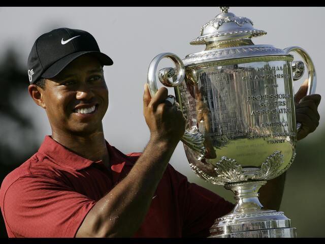 Tiger Woods holds up the Wanamaker Trophy after winning the 89th PGA Golf Championship, in Tulsa, Oklahoma, August 2007.