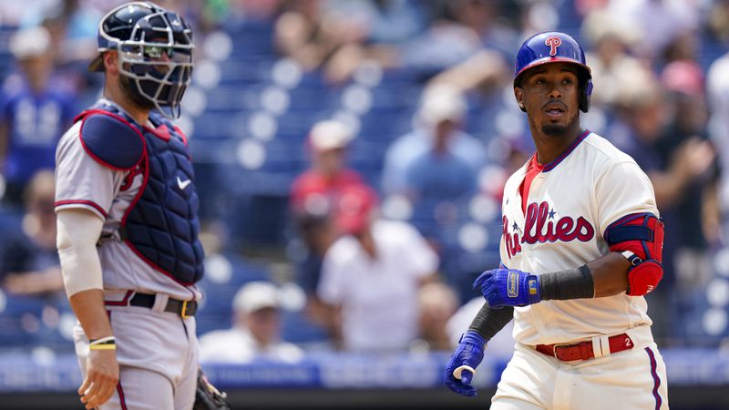 Philadelphia Phillies' Jean Segura (right) looks on following his home run with Braves catcher Kevan Smith (left) during the fourth inning Sunday, July 25, 2021, in Philadelphia. (Chris Szagola/AP)