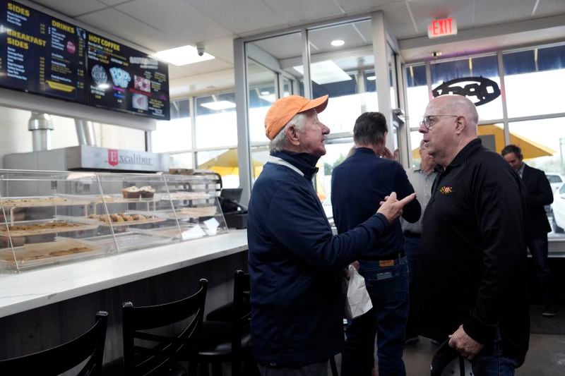 Former Maryland Gov. Larry Hogan, right, talks with patrons of DePaola's Bagel and Brunch in Stevensville, Md., Friday, April 12, 2024, as he campaigns for the U.S. Senate. (AP Photo/Susan Walsh)