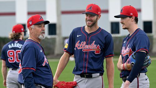 Atlanta Braves starting pitcher Chris Sale (center) and  starting pitcher Max Fried (right) smile as they talk with pitching coach Rick Kranitz during spring training workouts at CoolToday Park, Saturday, February, 17, 2024, in North Port, Florida. (Hyosub Shin / Hyosub.Shin@ajc.com)