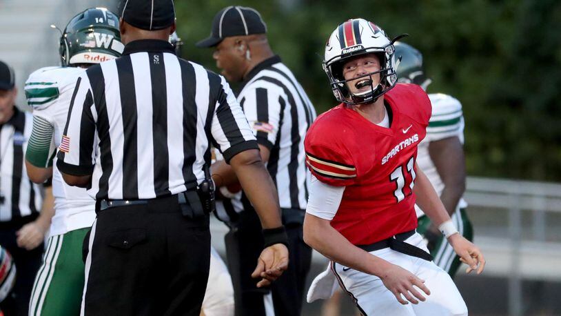 GAC quarterback Josh Rose (11) celebrates his rushing touchdown in the first half against Westminster at Greater Atlanta Christian Friday, August 24, 2018, in Norcross, Ga. PHOTO / JASON GETZ