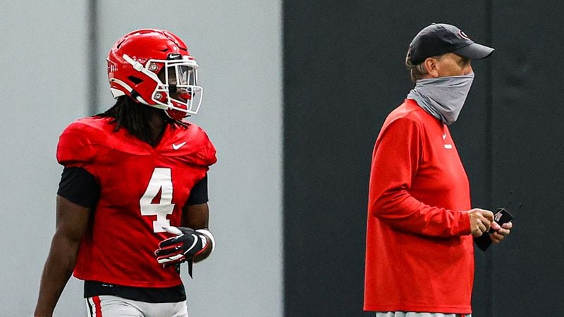 Georgia running back James Cook (4) and offensive coordinator and quarterbacks coach Todd Monken during the Bulldogs' practice Monday, Aug. 24, 2020, in Athens. (Tony Walsh/UGA Sports)