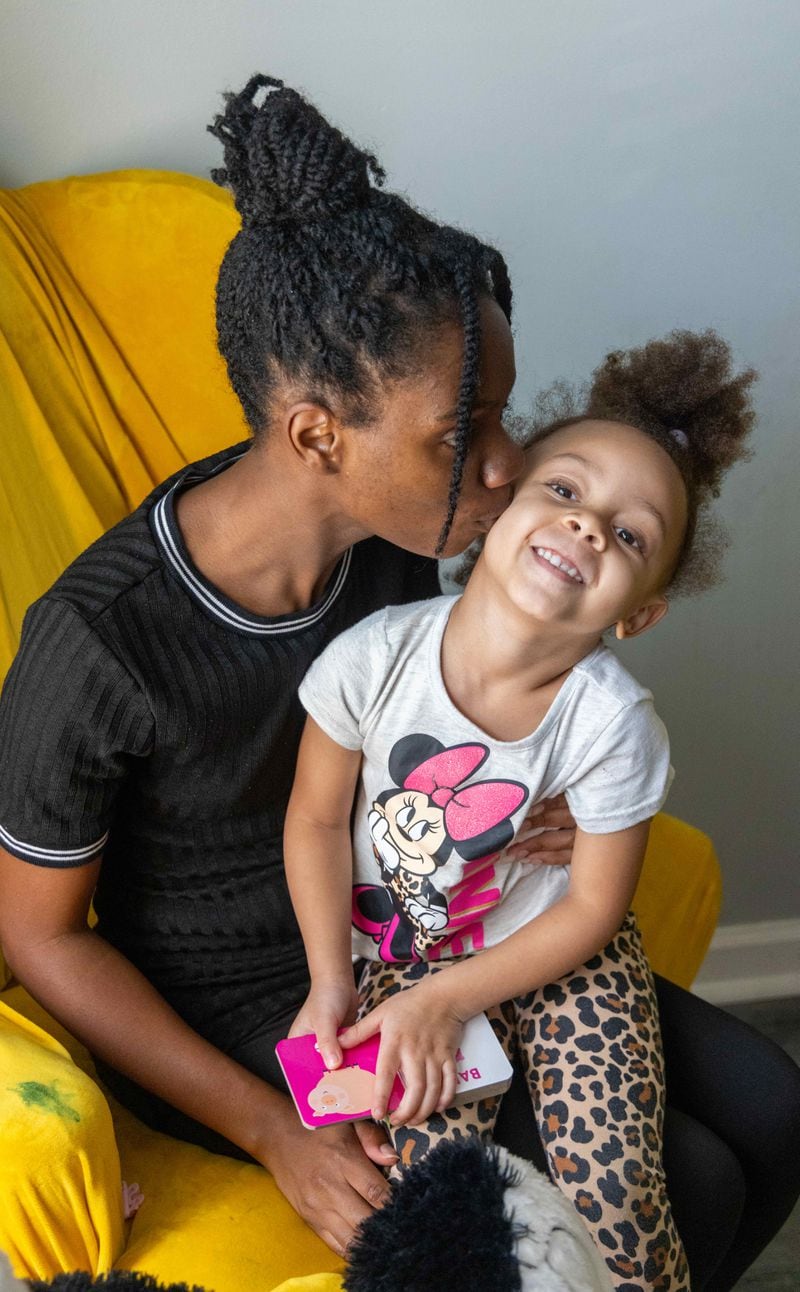 Tannyetta Robinson kisses her 4-year-old daughter Ayla in their Atlanta townhouse. PHIL SKINNER FOR THE ATLANTA JOURNAL-CONSTITUTION