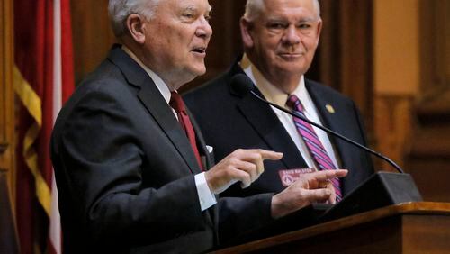 Gov. Nathan Deal, left, made the rounds Thursday night, speaking to both chambers of the Legislature. He warned lawmakers, including House Speaker David Ralston, right, that he may not sign all the bills they passed. BOB ANDRES /BANDRES@AJC.COM