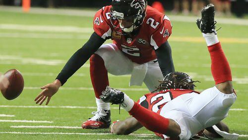 Matt Ryan can't handle a bad snap from center Mike Person, who was charged with a fumble in one of the Falcons' three first-half turnovers. (Curtis Compton/compton@ajc.com)