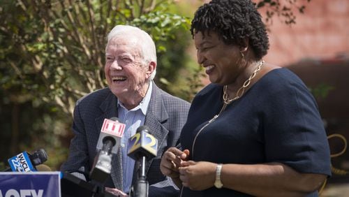 Former President Jimmy Carter and Stacey Abrams, the Democratic candidate to become Georgia’s next governor, share a laugh while taking questions during a press conference Tuesday on rural health care at the Mercer Medicine facility in Plains. (ALYSSA POINTER/ALYSSA.POINTER@AJC.COM)