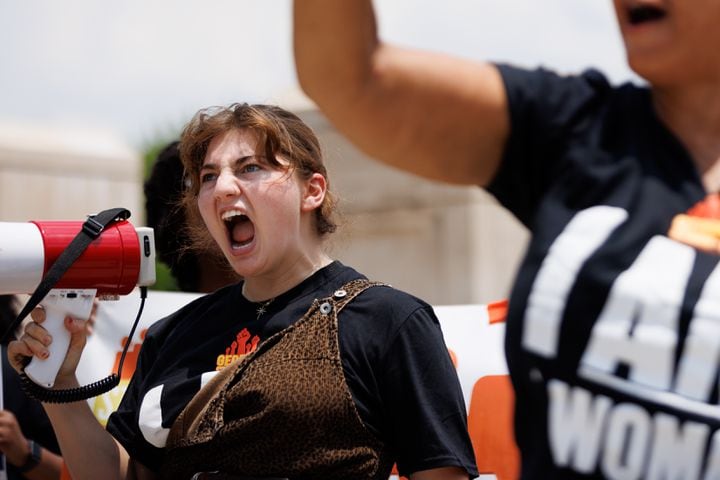 Abortion rights activist Hannah Risman leads a chant in a rally organized by Georgia Stand Up in front of the Georgia State Capitol on Friday, June 24, 2022. The rally follows the Supreme Court ruling overturning Roe v. Wade. (Arvin Temkar / arvin.temkar@ajc.com)