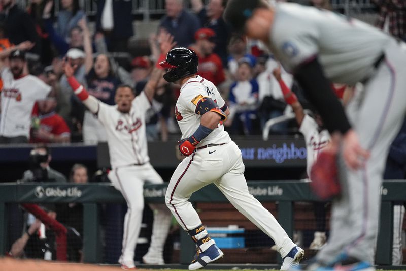Atlanta Braves Adam Duvall runs to first after hitting a two-run home run in the sixth inning of a baseball game against the Miami Marlins Tuesday, April 23, 2024, in Atlanta. (AP Photo/John Bazemore)