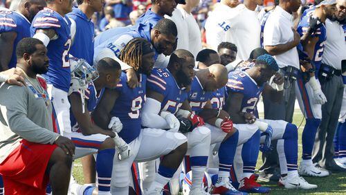 In this Sunday, Sept. 24, 2017, file photo, Buffalo Bills players take a knee during the playing of the national anthem before a home game against the Denver Broncos. President Trump said such protests are part of the reason NFL ratings and attendance are down. (AP Photo/Jeffrey T. Barnes, File)