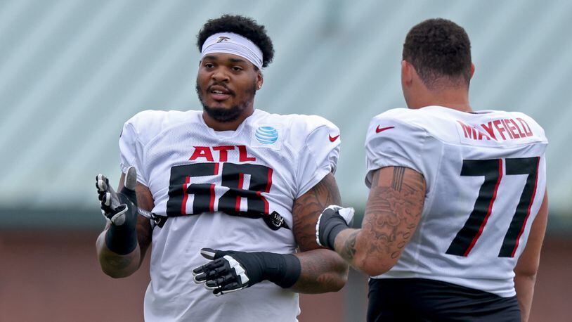 Falcons offensive tackle Elijah Wilkinson (68, left) talks with offensive tackle Jalen Mayfield (77) during training camp at the Falcons Practice Facility, Monday, August 1, 2022, in Flowery Branch, Ga. (Jason Getz / Jason.Getz@ajc.com)