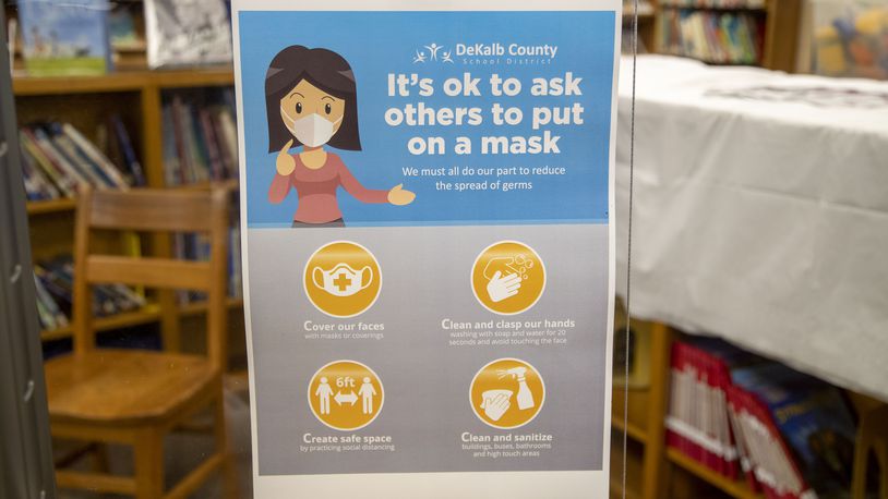 07/23/2021 — Decatur, Georgia — Signs advising DeKalb County School District visitors how to wear a mask will be displayed in the hallways of the school buildings, like this one, displayed at Kelley Lake Elementary School in Decatur, Friday, July 23, 2021. (Alyssa Pointer/Atlanta Journal Constitution)