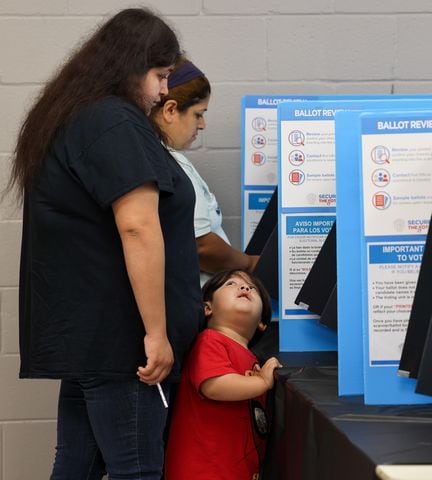 Two-year-old Adam Martinez watch his mother Carolina cast her ballot at The Nett Church at Berkmar Church in Lilburn. PHIL SKINNER FOR THE ATLANTA JOURNAL-CONSTITUTION