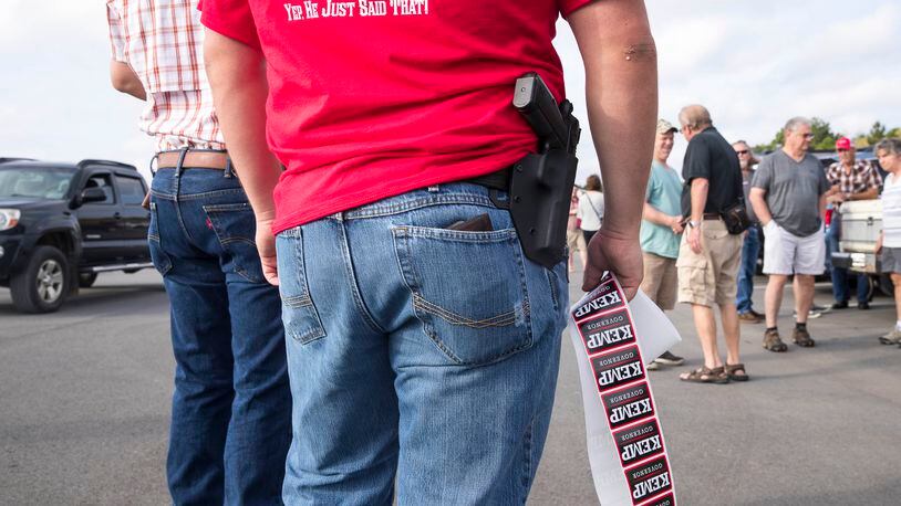 An Appalachian Gun, Pawn & Range employee hands out Brian Kemp campaign stickers during a campaign stop in Jasper in October 2018. Kemp recently visited a gun superstore in Smyrna to announce his No Guns Left Behind legislation. (ALYSSA POINTER/ALYSSA.POINTER@AJC.COM)