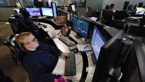 DeKalb County dispatchers assist callers at the 911 emergency center in Tucker on Friday. HYOSUB SHIN / HSHIN@AJC.COM