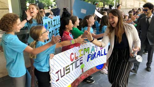 FILE - Kelsey Juliana, of Eugene, Ore., a lead plaintiff who is part of a lawsuit by a group of young people who say U.S. energy policies are causing climate change and hurting their future, greets supporters outside a federal courthouse, June 4, 2019, in Portland, Ore. A 9th U.S. Circuit Court of Appeals panel on Wednesday, May 1, 2024, rejected a long-running lawsuit brought by young Oregon-based climate activists who argued that the U.S. government's role in climate change violated their constitutional rights. (AP Photo/Andrew Selsky, File)