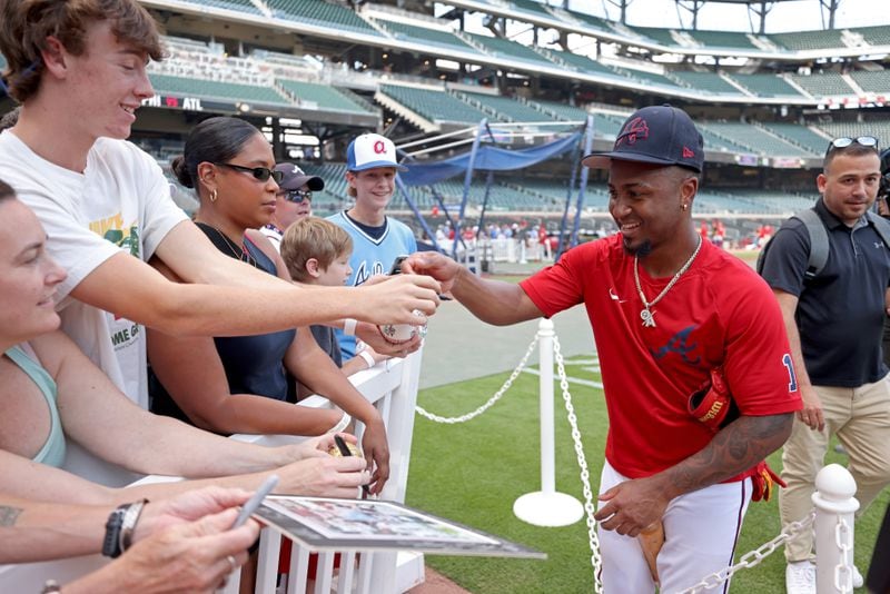 Braves second baseman Ozzie Albies signs autographs for fans before their game against the Philadelphia Phillies at Truist Park, Friday, September 16, 2022, in Atlanta. Albies is back for the Braves, rejoining the club after a months-long absence because of injury. (Jason Getz / Jason.Getz@ajc.com)
