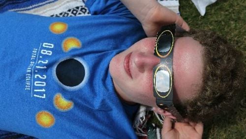 Gabriel Green, 16, of Dunwoody, takes in the total solar eclipse in Clayton, a city in the path of totality in North Georgia. CURTIS COMPTON / CCOMPTON@AJC.COM