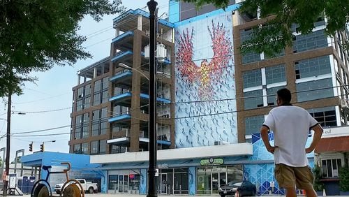 Atlanta artist Craig Alan's mural, "From the Ground Up," rises more than 90 feet over Howell Mill Road in West Midtown. 
Courtesy of 8West