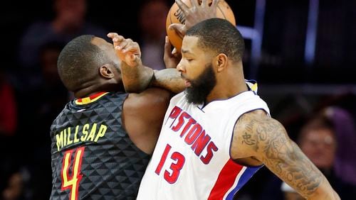 Atlanta Hawks forward Paul Millsap (4) is fouled by Detroit Pistons forward Marcus Morris (13) during the second half of an NBA basketball game, Wednesday, Jan. 18, 2017, in Auburn Hills, Mich. (AP Photo/Carlos Osorio)