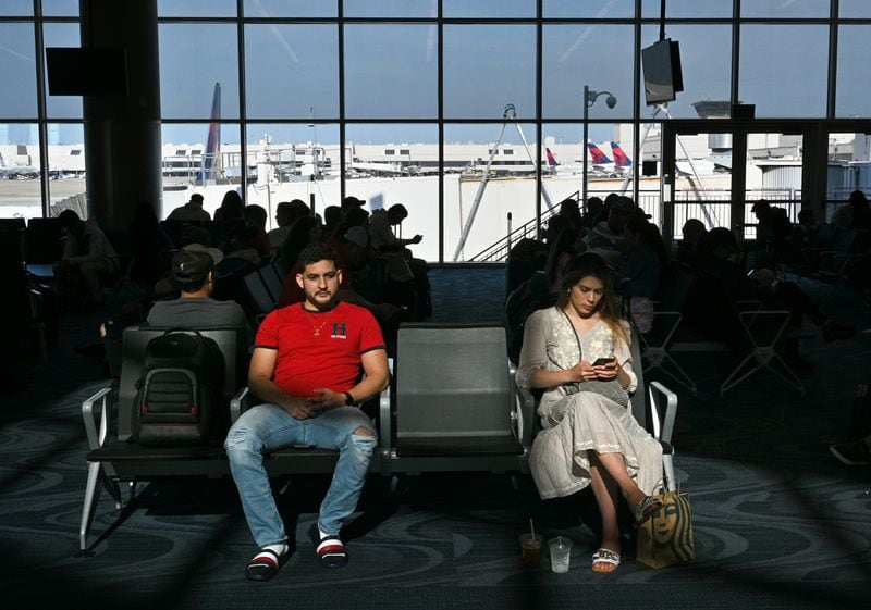 International travelers wait to board a flight in Atlanta's Maynard H. Jackson Jr. International Terminal on Friday, April 29, 2022. (Hyosub Shin / Hyosub.Shin@ajc.com)