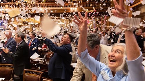 State representatives throw paper in the air to celebrate the end of the legislative session at the House of Representatives in the Georgia Capitol in Atlanta on Sine Die, Thursday, March 28, 2024. (Arvin Temkar / arvin.temkar@ajc.com)