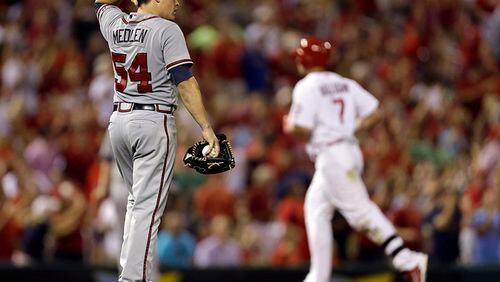 St. Louis Cardinals' Matt Holliday (background) rounds the bases after hitting a solo home run off Atlanta Braves starting pitcher Kris Medlen in the sixth inning of a 3-1 Braves loss Friday in St. Louis.