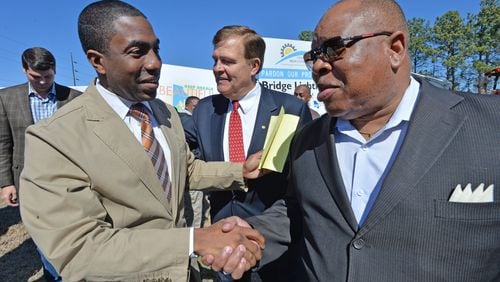 Lee May (left), at the time DeKalb County’s interim CEO, greets Stan Watson, at the time a commissioner, before an event on March 14, 2014, in Stone Mountain. HYOSUB SHIN / HSHIN@AJC.COM