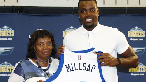 Denver Nuggets new forward Paul Millsap, right, holds up his jersey with his mother, Bettye, during the player's introduction to the media at a news conference Thursday, July 13, 2017, in Denver. (AP Photo/David Zalubowski)