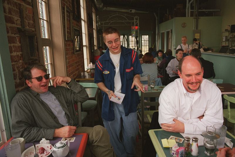 Calvino Donati greets customers Bert Robertson and Rick Jones at Roman Lily Cafe. / AJC file photo
