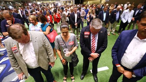 Georgia Insurance Commissioner John King, his wife, Carol, and Gov. Brian Kemp's supporters pray for shooting victims in Texas during Kemp's election night party Tuesday at the College Football Hall of Fame in Atlanta. “Curtis Compton / Curtis.Compton@ajc.com”