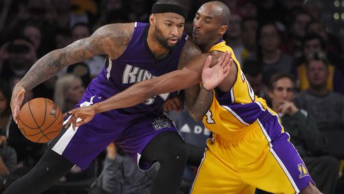 Los Angeles Lakers forward Kobe Bryant, right, reaches in on Sacramento Kings center DeMarcus Cousins during the second half of an NBA basketball game Wednesday, Jan. 20, 2016, in Los Angeles. The Kings won 112-93. (AP Photo/Mark J. Terrill)