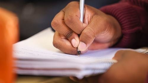 A Morehouse College student writes during the Eddie Gaffney lecture series about mental health at Dansby Hall on the Morehouse College campus, Tuesday, October 17, 2023, in Atlanta. (Jason Getz / Jason.Getz@ajc.com)
