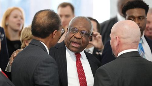 U.S. Supreme Court Justice Clarence Thomas talks with U.S. District Judge Steve Jones (left) after a ceremony on Tuesday, Feb. 11, 2020, in Atlanta. Thomas was the keynote speaker for the dedication of the Nathan Deal Judicial Center. (credit: Miguel Martinez for The Atlanta Journal-Constitution)