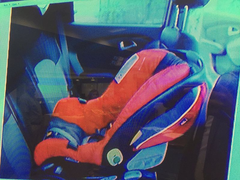 The prosecution shows the jury a crime scene photo that shows how Cooper's car seat was positioned in the back seat of the SUV, during Justin Ross Harris' murder trial at the Glynn County Courthouse in Brunswick, Ga., Wednesday, Oct. 5, 2016. (screen capture via WSBTV)