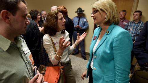 State Rep.Beth Beskin, R-Atlanta, (right) listens in the aftermath of a 2015 hearing at the state Capitol. AJC file