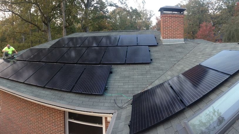 A worker installs solar panels on a Druid Hills home under Solarize Decatur-DeKalb’s program. Photo courtesy of Creative Solar USA.