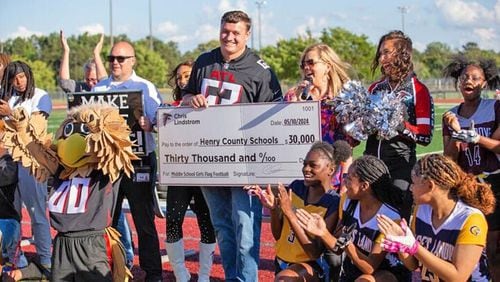 Atlanta Falcons player Chris Lindstrom - along with Falcons cheerleaders, mascot Freddie Falcon, and other Falcons representatives -  presented a $30,000 donation to Henry County Schools to fund middle school girls flag football. (Photo Courtesy of Toni Lee)