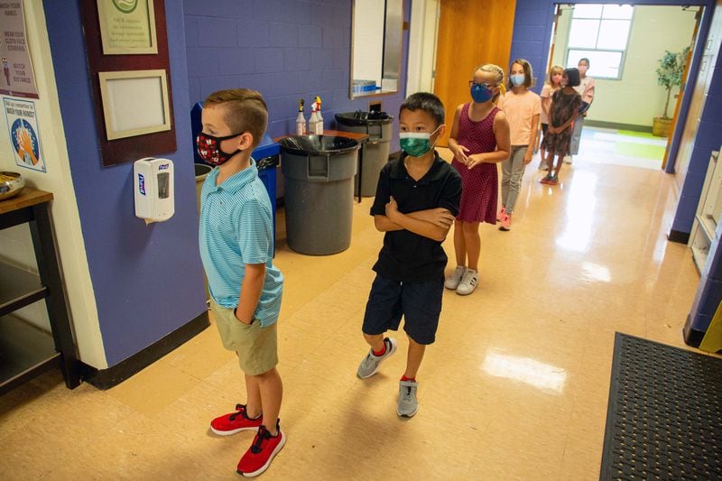 Students line up for lunch at The Walker School in Marietta Friday, August 20, 2021. The students are allowed to eat maskless during lunch but must sit 4 feet away from each other.   STEVE SCHAEFER FOR THE ATLANTA JOURNAL-CONSTITUTION