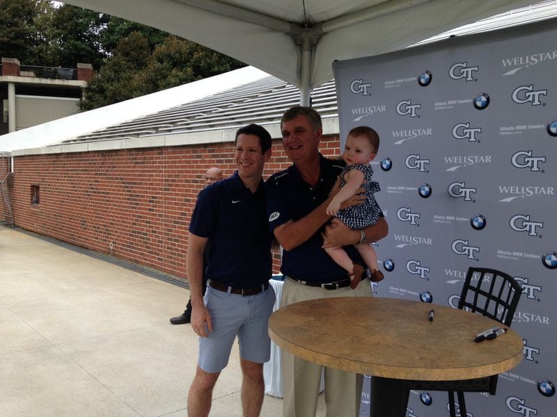 Georgia Tech coach Paul Johnson with two fans at the team's fan day Saturday at Bobby Dodd Stadium.