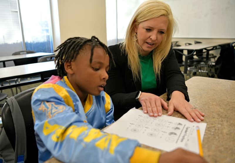 Georgia Gwinnett College professor Amber Jarrard Ebert helps Jeremiah Moon during the Grizzly Academy Dreamers after-school program for Gwinnett County students. (Courtesy of Georgia Gwinnett College)