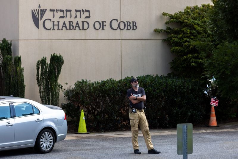 A guard is seen in front of Chabad of Cobb in Marietta on Monday, June 26, 2023. A group of neo-Nazis demonstrated in front of the synagogue over the weekend. (Arvin Temkar / arvin.temkar@ajc.com)